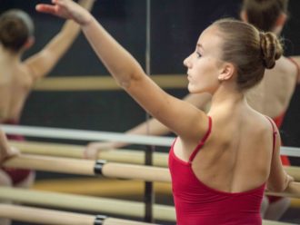 ballerina posing on barre.